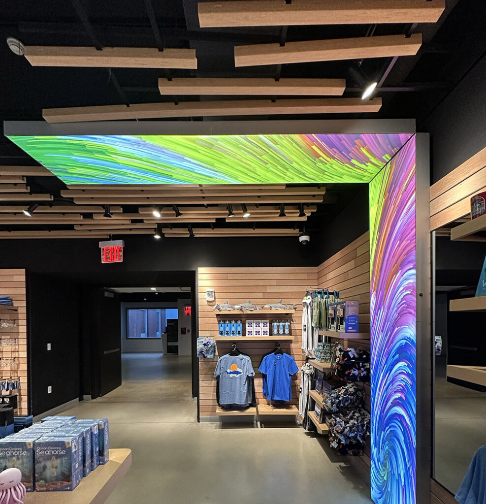 At the Natural History Museum New York, floating horizontal lightbox panels create immersive, illuminated retail graphics.